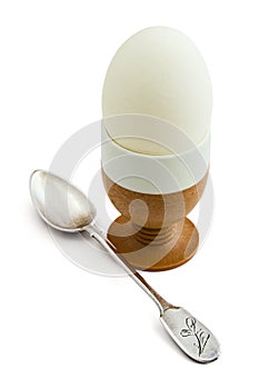 Egg in eggcup and teaspoon isolated