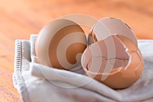 Egg and eggshells on the kitchen dishtowel with natural moody backlight