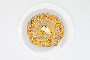 Egg Everything Bagel with Cream Cheese on a White Plate with a White Background