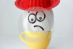 An egg with a face. Funny and sweet. SAD IN THE HAT.