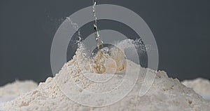 Egg Falling on Flour