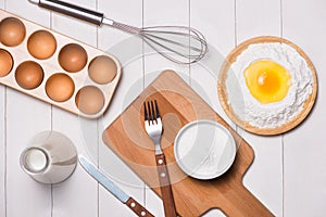 Egg in flour. Making dough background. Baking with raw eggs, sugar, flour , milk