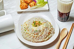 Egg Fried Rice with Dancing Sakura Shrimp, Fried squid balls, Taiwanese red bean ice tea served in dish isolated on marble photo