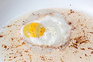 Egg frying in bacon grease