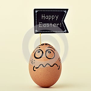 egg with a funny face with a signboard with the text happy easter