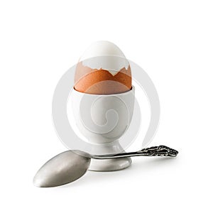 Egg holder with brown chicken egg and spoon. Healthy breakfast