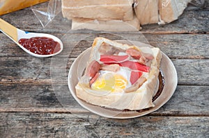 Egg, hotdog and crab stick in bread