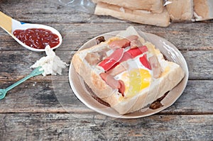 Egg, hotdog and crab stick in bread