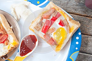 Egg, hotdog and crab stick in a hole of bread