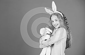 Egg hunt. Family holiday. Spring party. Little girl with hare toy. Happy easter. Child in rabbit bunny ears. copy space