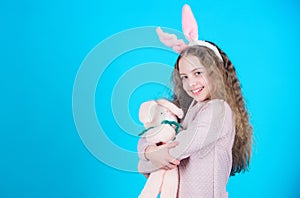 Egg hunt. Family holiday. Spring party. Little girl with hare toy. Happy easter. Child in rabbit bunny ears. copy space