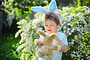 Egg hunt on spring holiday. Rabbit kid with bunny ears. Hare toy. Little boy child in green forest. love easter. Family