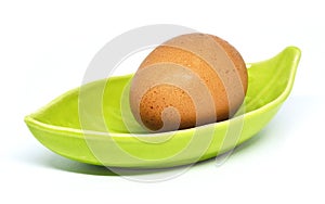 Egg and leaf plate on white background