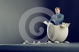 Egg with man inside isolated on gray background