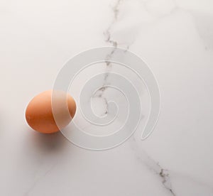 Egg on marble table as minimalistic food flat lay, top view food brand photography flatlay and recipe inspiration for cooking blog