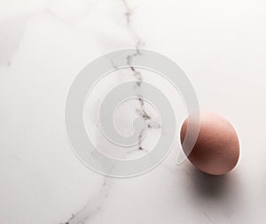 Egg on marble table as minimalistic food flat lay, top view food brand photography flatlay and recipe inspiration for cooking blog