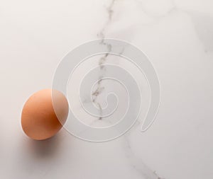 Egg on marble table as minimalistic food flat lay, top view food brand photography flatlay and recipe inspiration for cooking blog