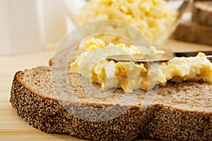Egg Mayonnaise being Spread on Bread