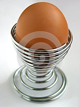 Egg in metal spiral eggcup photo