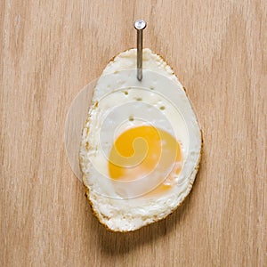 Egg nailed to wood. photo