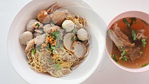 Egg noodle dry with bone soup top view and close up