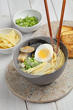 Egg noodle soup with bamboo shoots, tofu, and nori
