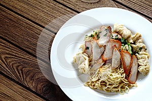 Egg noodles with red roast pork, dumpling, wontons and veget