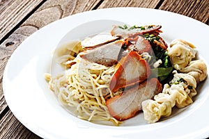 Egg noodles with red roast pork, dumpling, wontons and veget