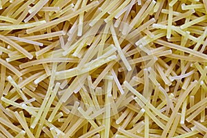 Egg noodles or spaghetti pasta, macaroni, noodle texture background macro closeup Top View. Concept of healthy eating