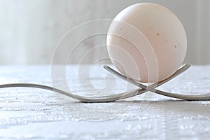 Egg over two forks as a monument close-up, macro