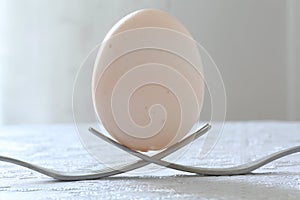 Egg over two forks as a monument close-up, macro