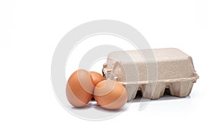 Egg in paper box isolated in white background. Eggs in carton. Green packaging. Chicken eggs from organic farm. Brown cardboard