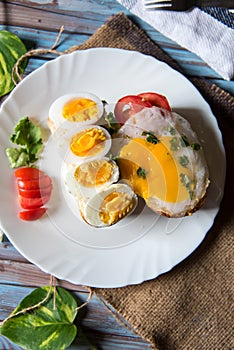 Egg poach, boiled egg slices and bacon are popular for the taste buds photo