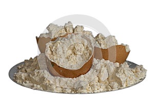 Egg protein powder on a plate and egg shells isolated on white background.