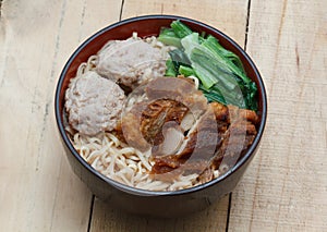 Egg rice noodles served with crispy pork and pork ball bounce.