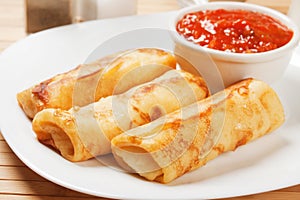 Egg rolls with tomato sauce