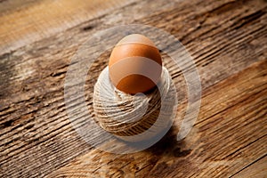 Egg in rope coil on old