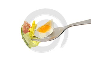 Egg and salad on fork