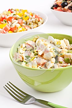 Egg salad in a green bowl with fork