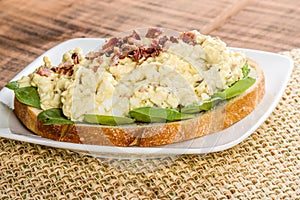 Egg salad sandwhich on a white plate