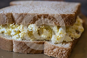 An egg salad sandwich on fresh bread ready to eat.