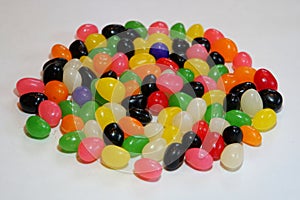 Egg-shaped jelly beans candies on a white isolated background