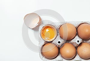Egg shell yolk breaked together on white background paralleled