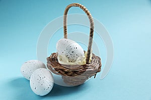 Egg in a small decorative basket on a blue background