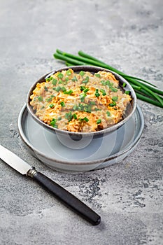 Egg spread with green onions and curry on grey background