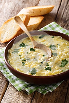 Egg stracciatella with farfalline pasta and cheese close-up in a