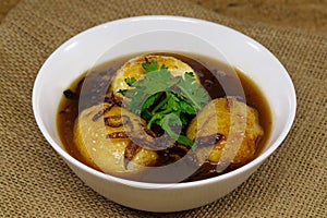 Egg with Tamarind Sauce on sack cloth background