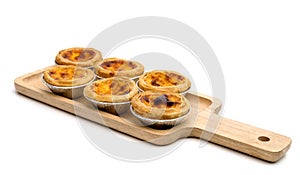 Egg tart in aluminum foil cup isolated on white background