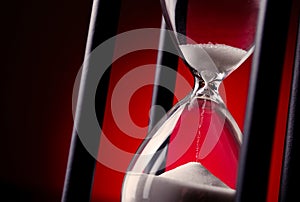 Egg timer or hourglass on a red background