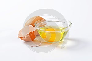 Egg white and yolk in glass bowl